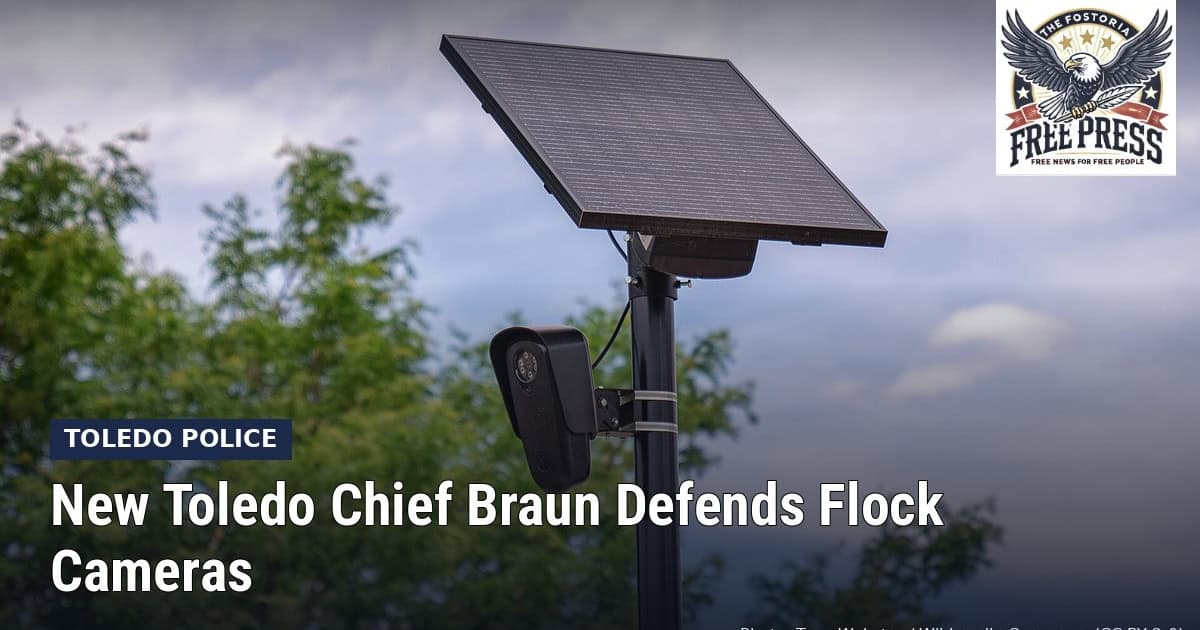 Fostoria News Toledo police camera and solar panel fence with Free Press logo.